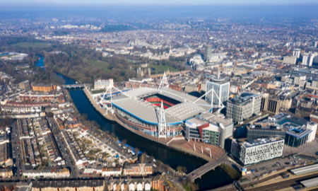 Cardiff aerial view Wales capital cityscape panoramic skyline feat. River Taff and city center in UK with Principality Stadium home of Welsh rugby union, plus football around town center from above.