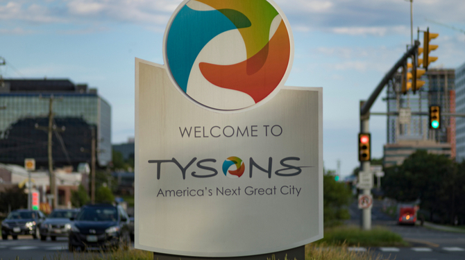 Tysons Corner: Welcome to Tysons America's Next Great City” sign on Route 7 Leesburg Pike in early morning.